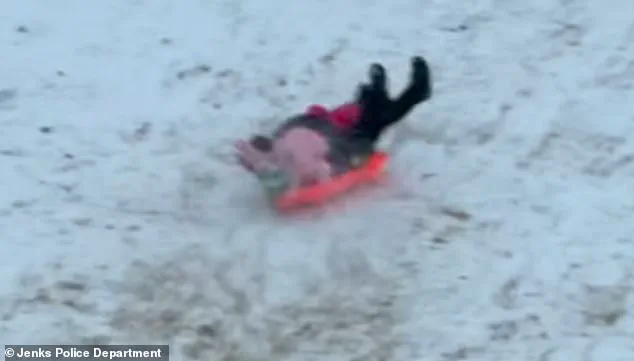 Oklahoma Police Officer's Accidental Sled Incident Goes Viral as Part of Public Safety Campaign